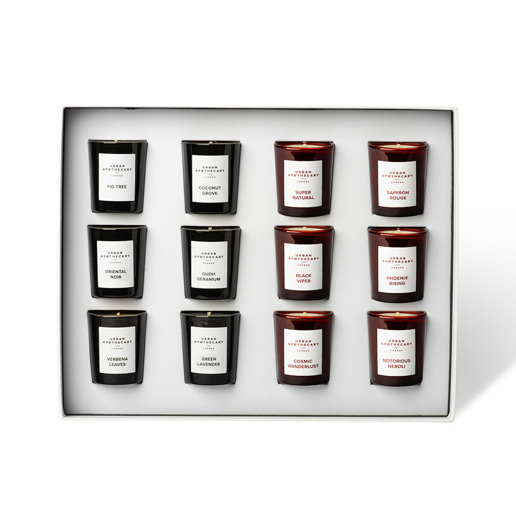 Set of twelve candles in a decorative box with labels on a white background